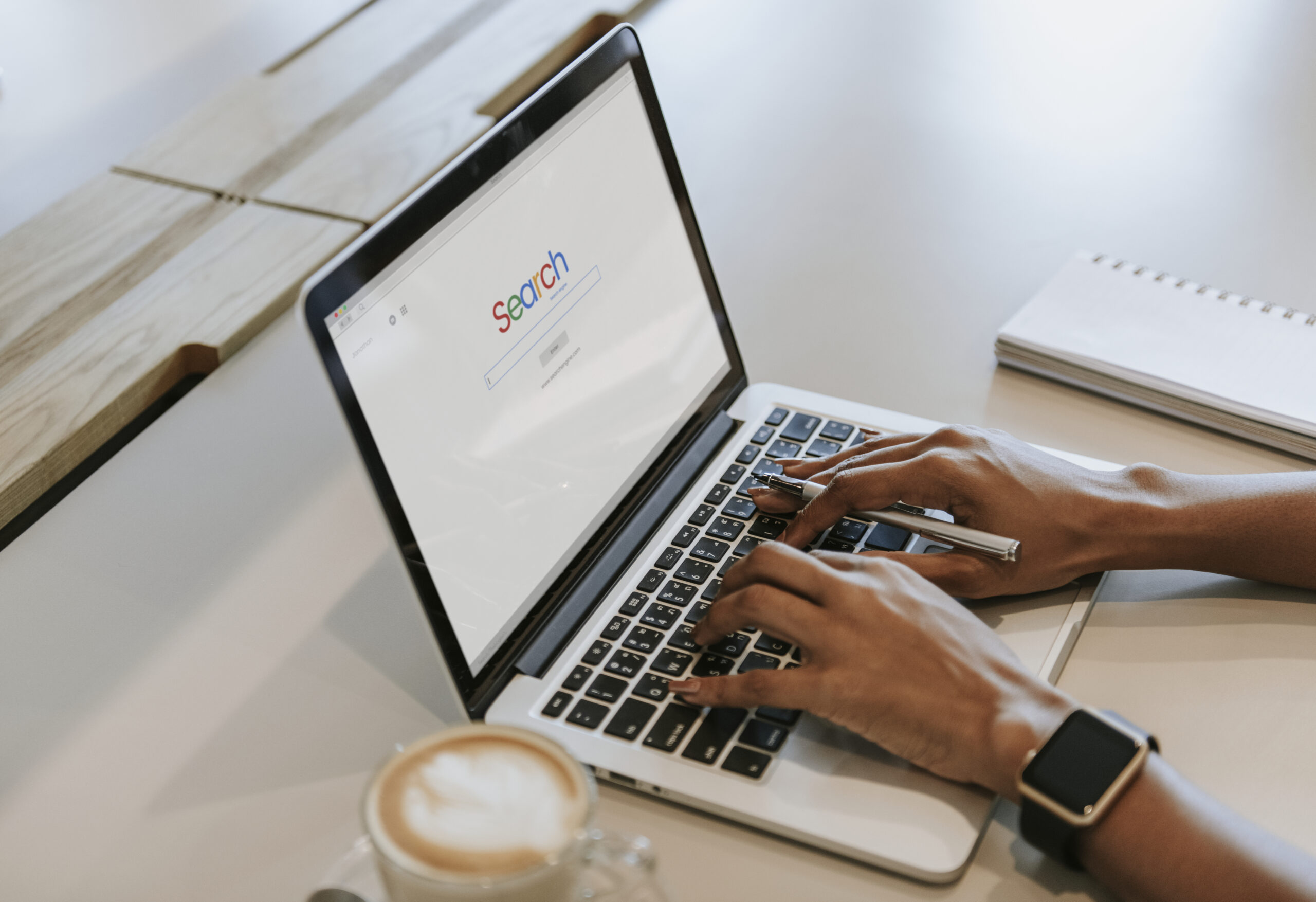 Person searching on a website with Search bar on the screen