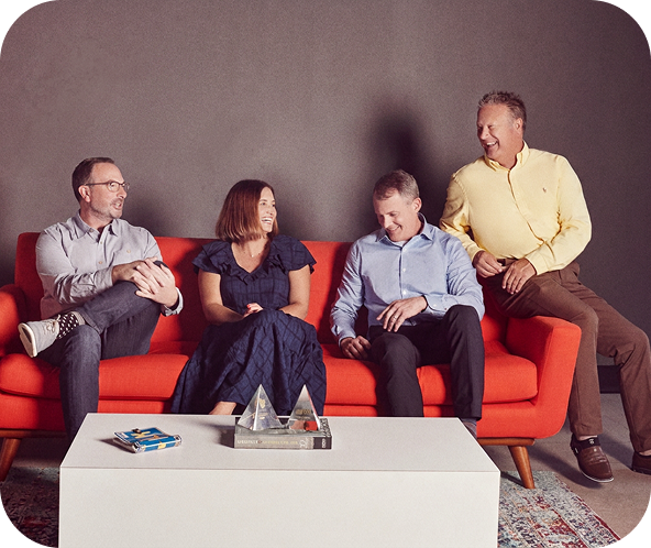 Four of Brunner's leadership team sitting on a couch talking