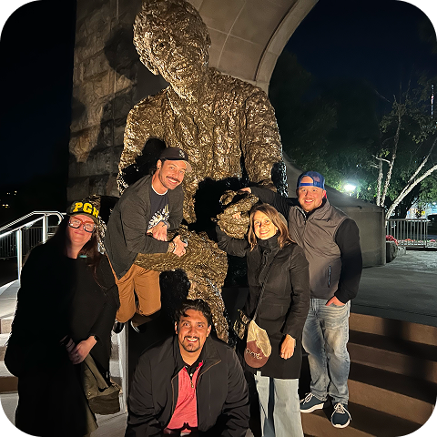 Brunner employees standing in front of a statue posing for a photo