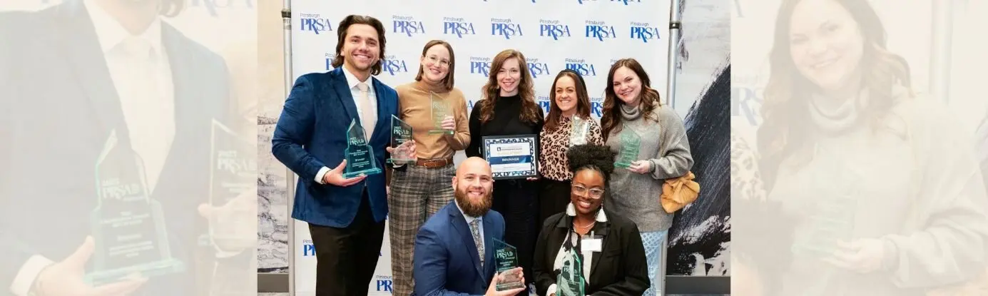 Group Posing With PRSA Awards At Event
