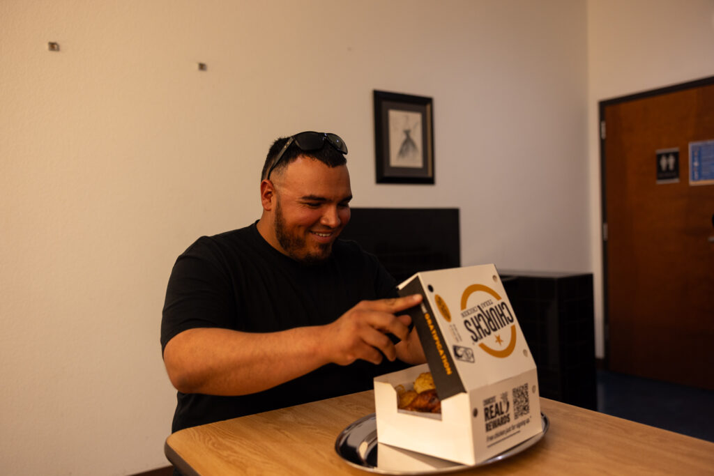Man opening box of Church's Texas Chicken