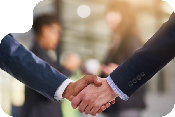 Two people shaking hands only arms and hands are shown