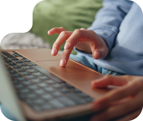 close up of a hand typing on a laptop