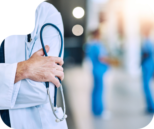 close up of a person in a white lab coat holding a stethoscope with arms crossed