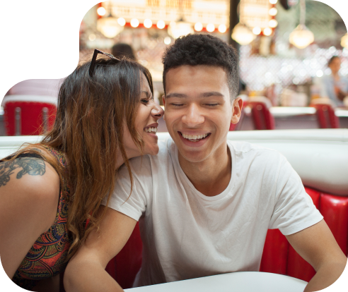 Close together couple laughing in a restaurant