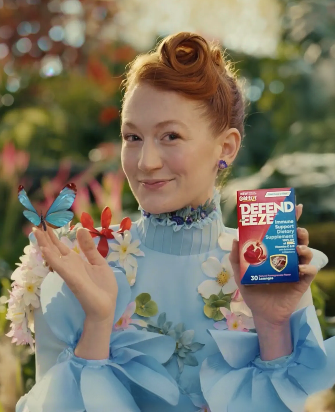 Woman holding a Defend Eeze product surrounded by flowers