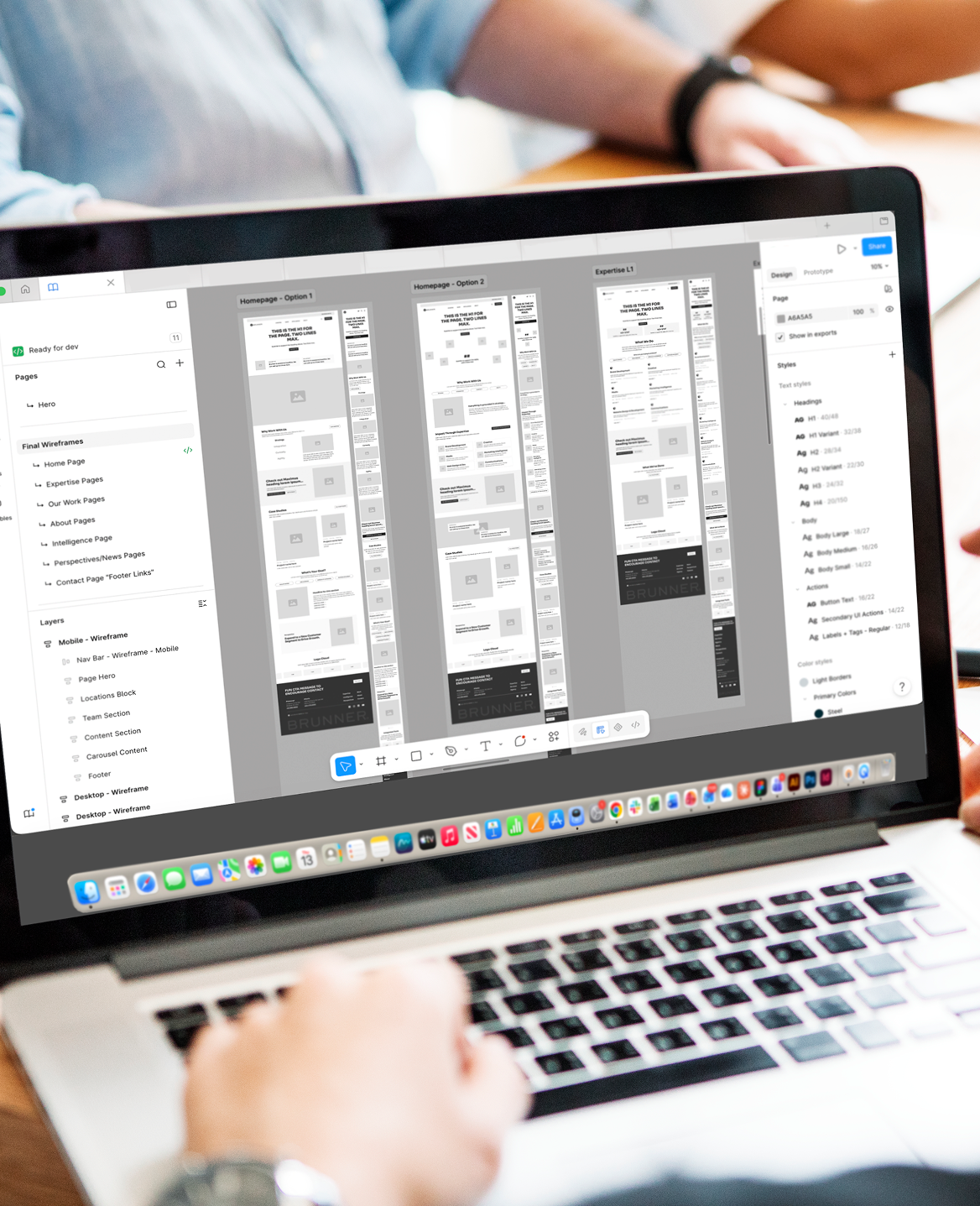 Person reviewing wireframes on a laptop