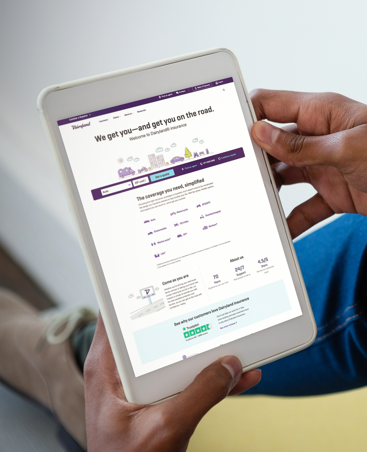 Person holding a tablet showing a responsive website