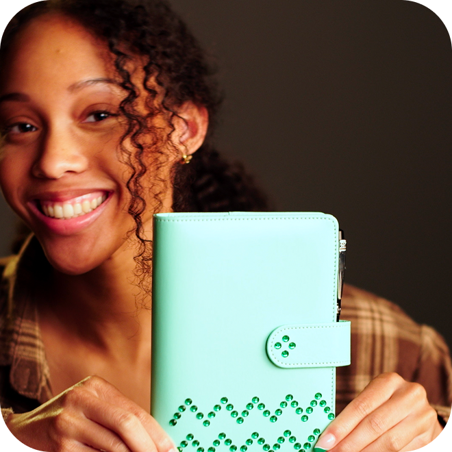 A person holding up a light green wallet