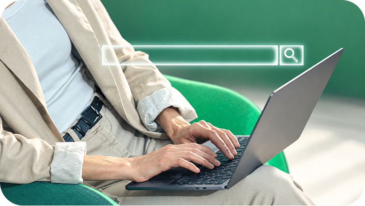 A person typing on a laptop with a search bar overlaying the image.