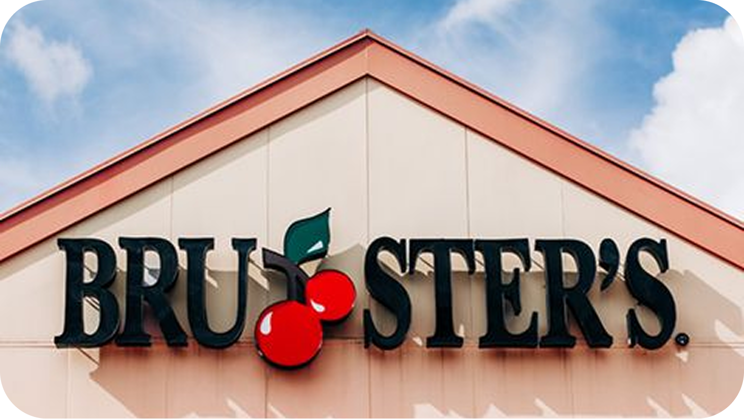 Front of a Bruster's Ice Cream store with the Bruster's sign and there is two cherries between the U and the S