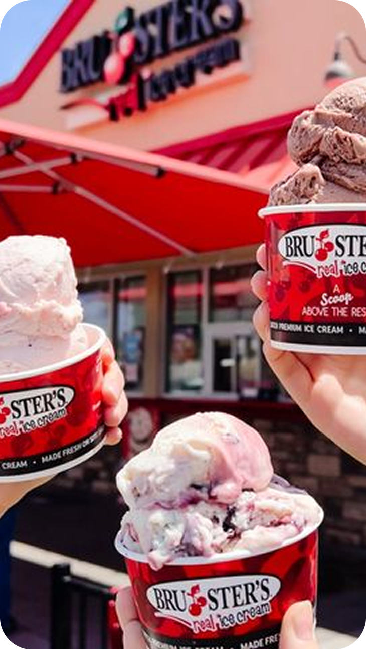 Three people holding cups of Bruster's Ice Cream