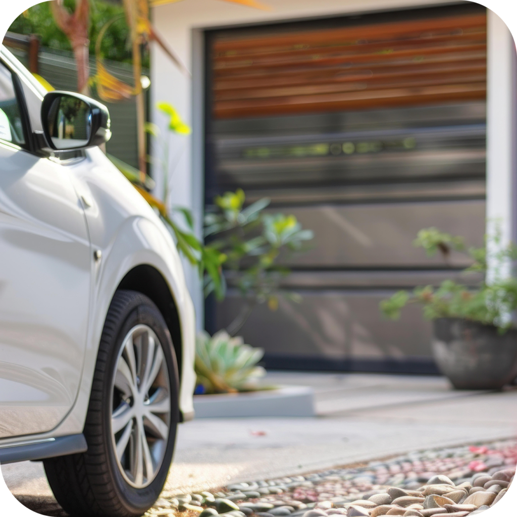 the front of a Chevy car pulling in front of a garage door
