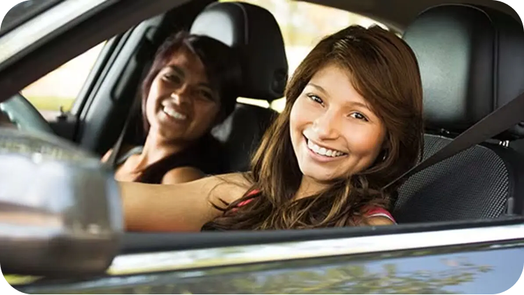 A close up of two people driving in a car. One driver and one passenger