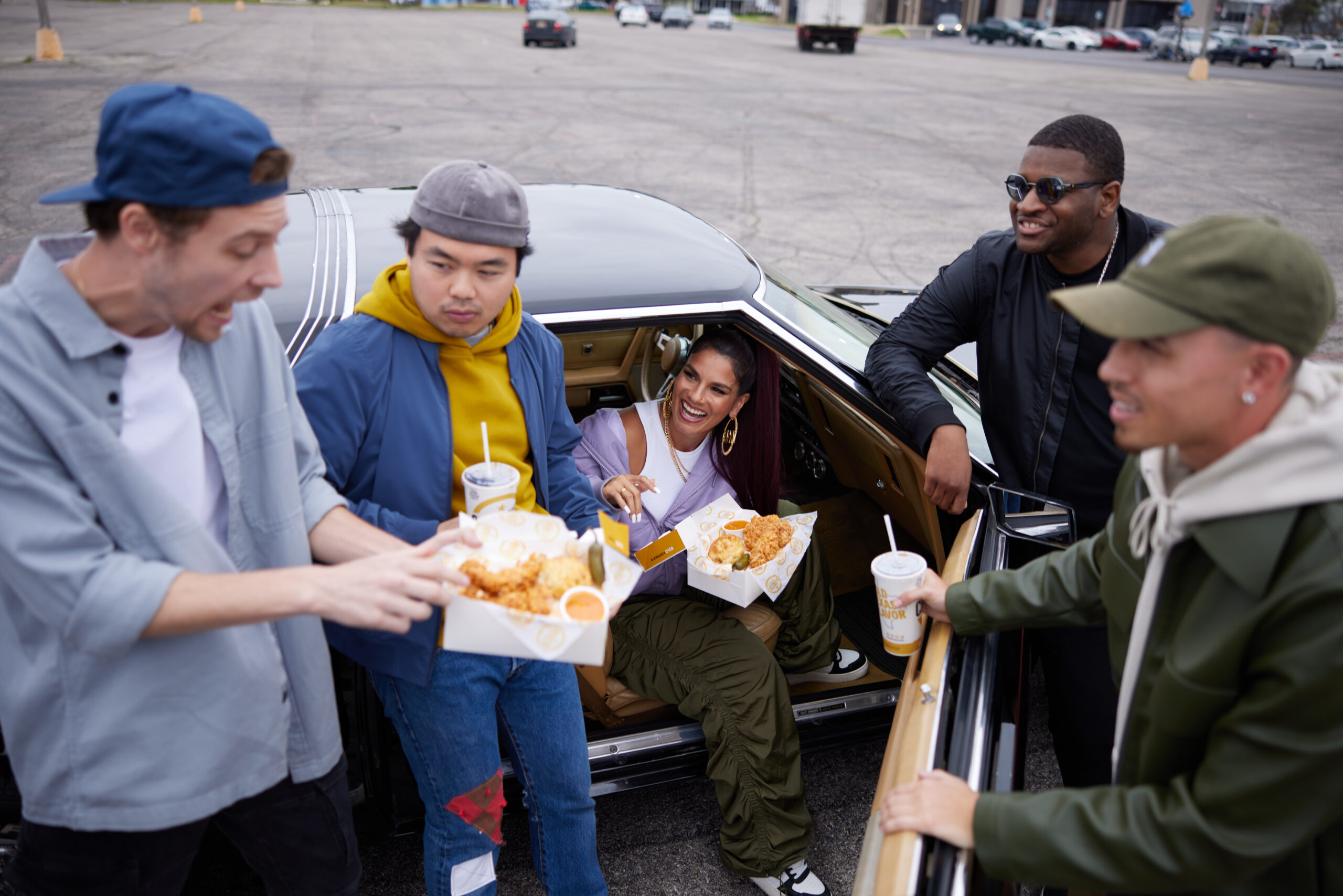 Friends Sharing Church's Texas Chicken Around A Car