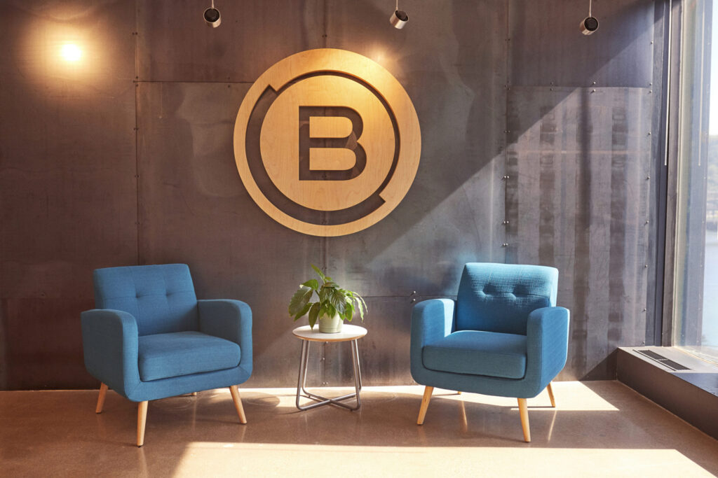 Brunner Logo On Office Wall Above Blue Armchairs