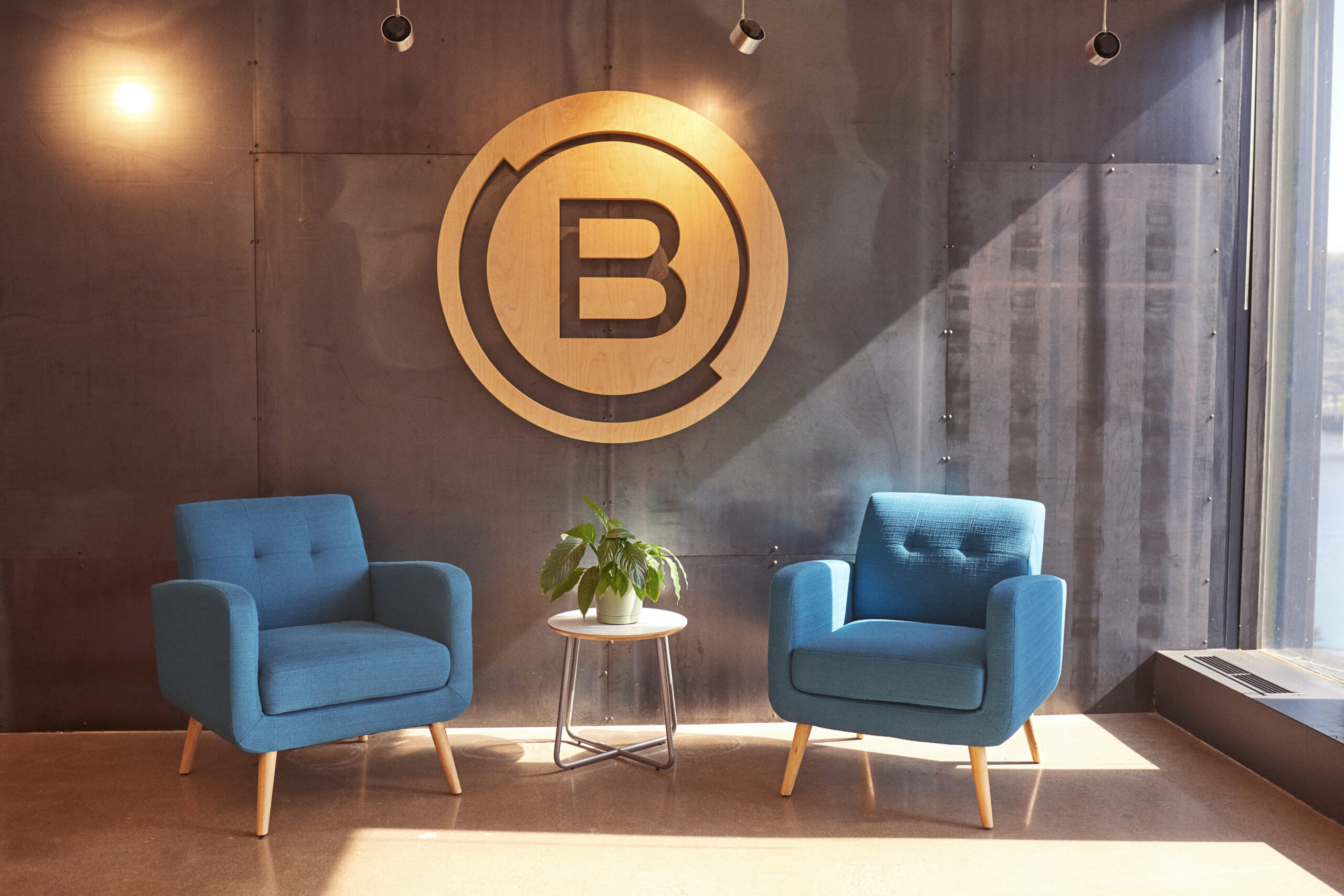 Brunner Logo On Office Wall Above Blue Armchairs