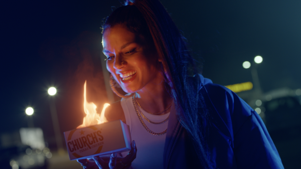 Woman Holding Flaming Church's Texas Chicken Box