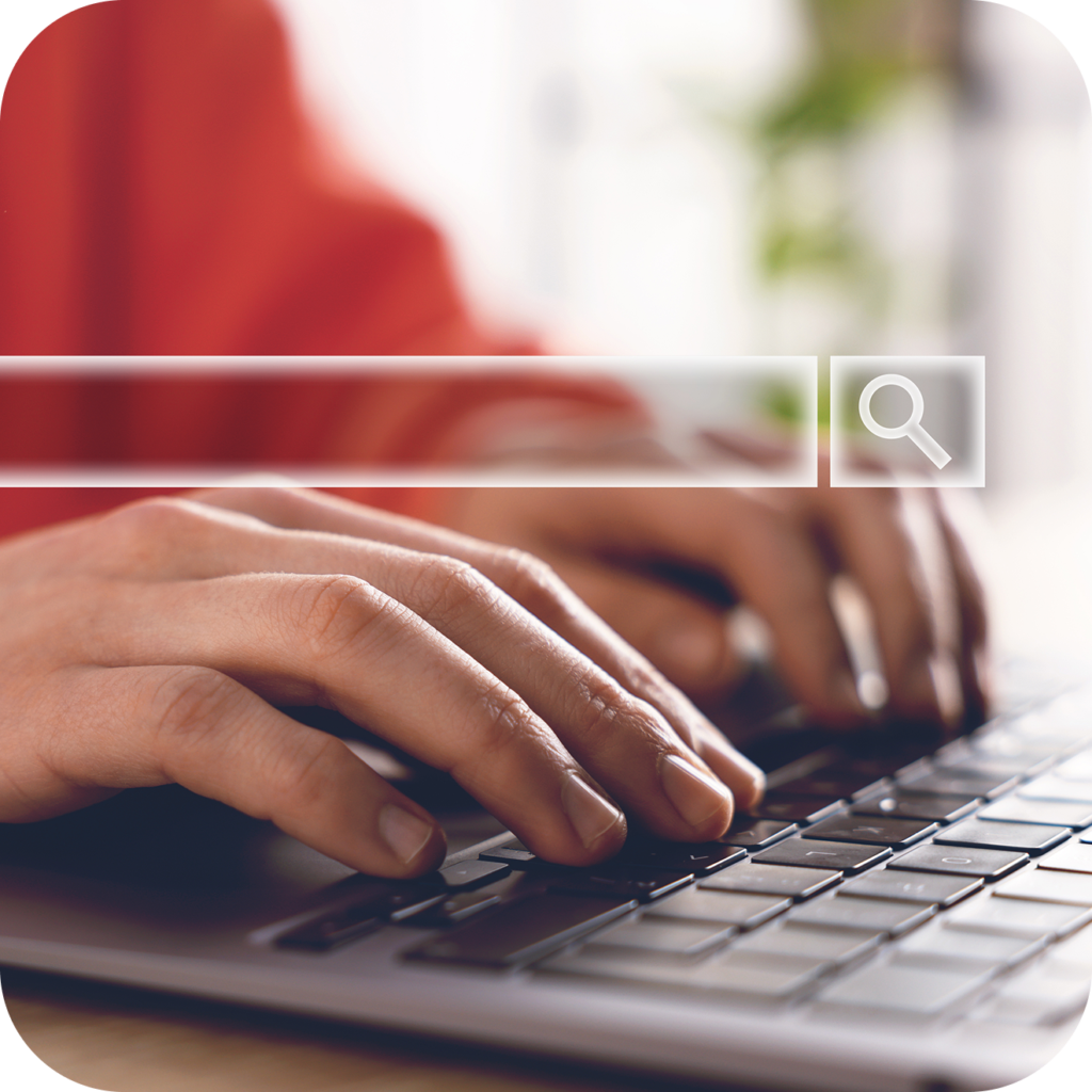 Person typing on a keyboard with a search field overlayed